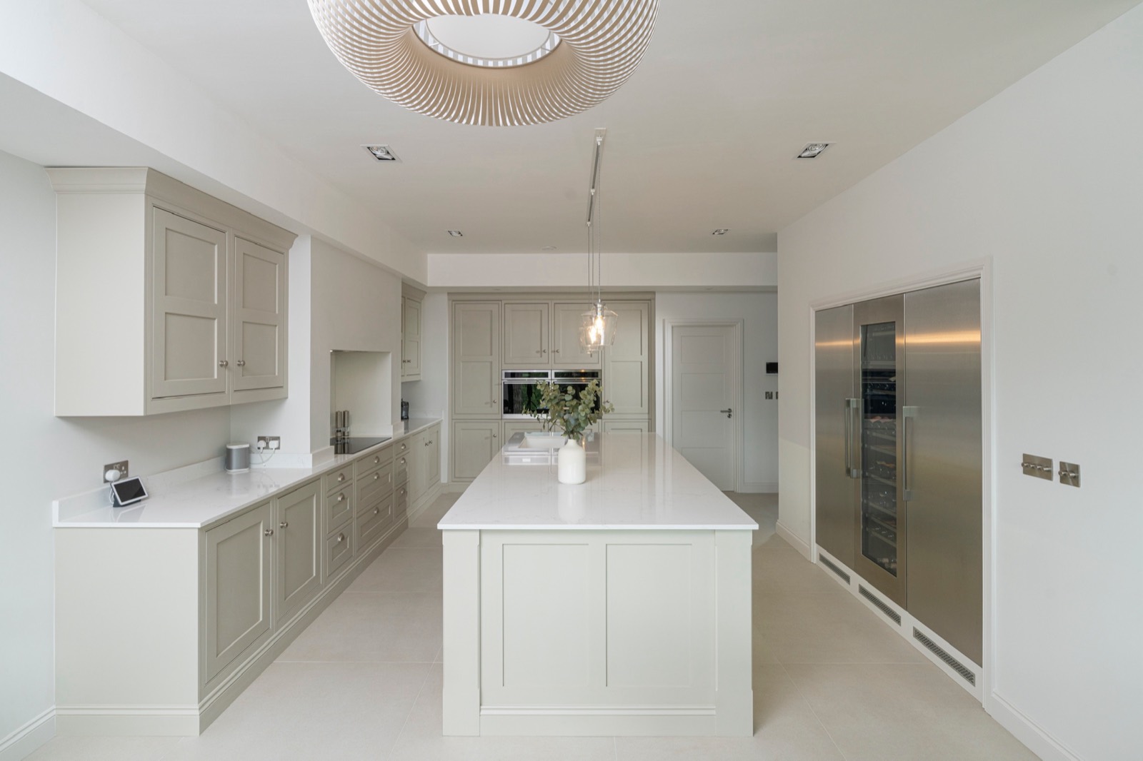 The whole kitchen: island, tall units and an integrated fridge